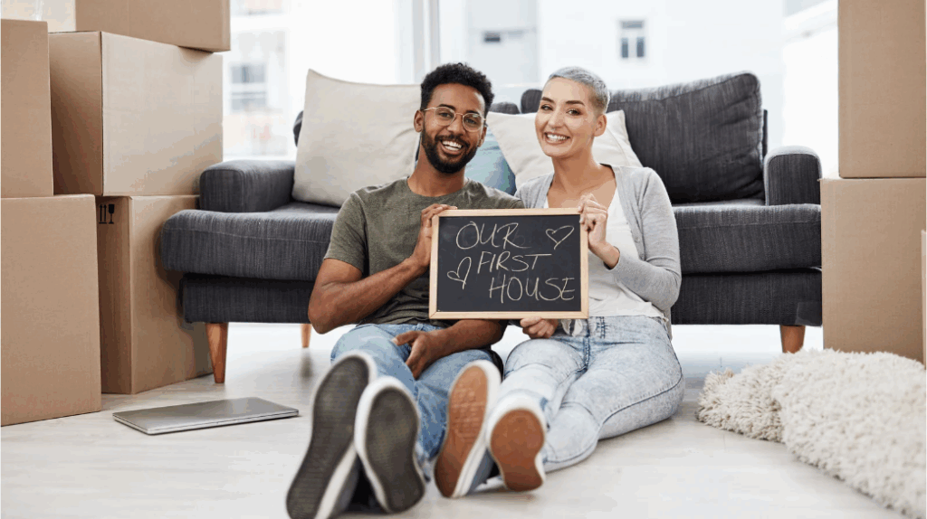 Young couple who are first time homebuyers in their newly purchased home with Bobby Franklin