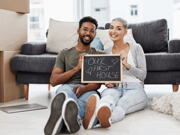 Young couple who are first time homebuyers in their newly purchased home
