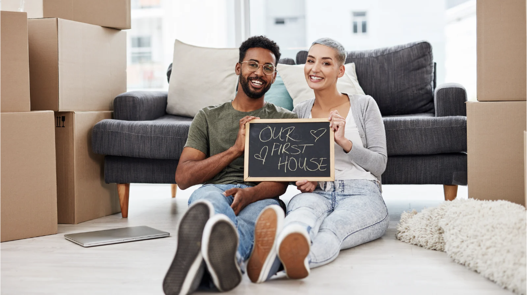 Young couple who are first time homebuyers in their newly purchased home