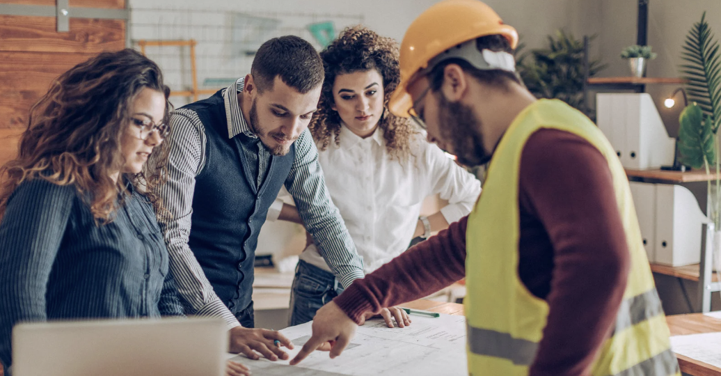 Home buyers reviewing plans with their builder and real estate agent