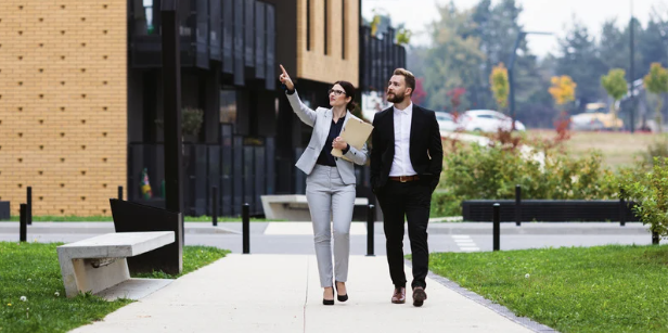 Real estate agent walking with their client showing Homes