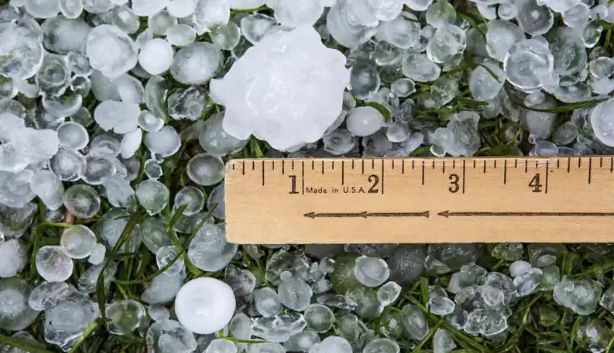 Large Texas hail set against a ruler